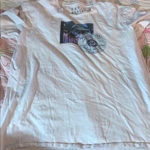 White shirt with disk and trees